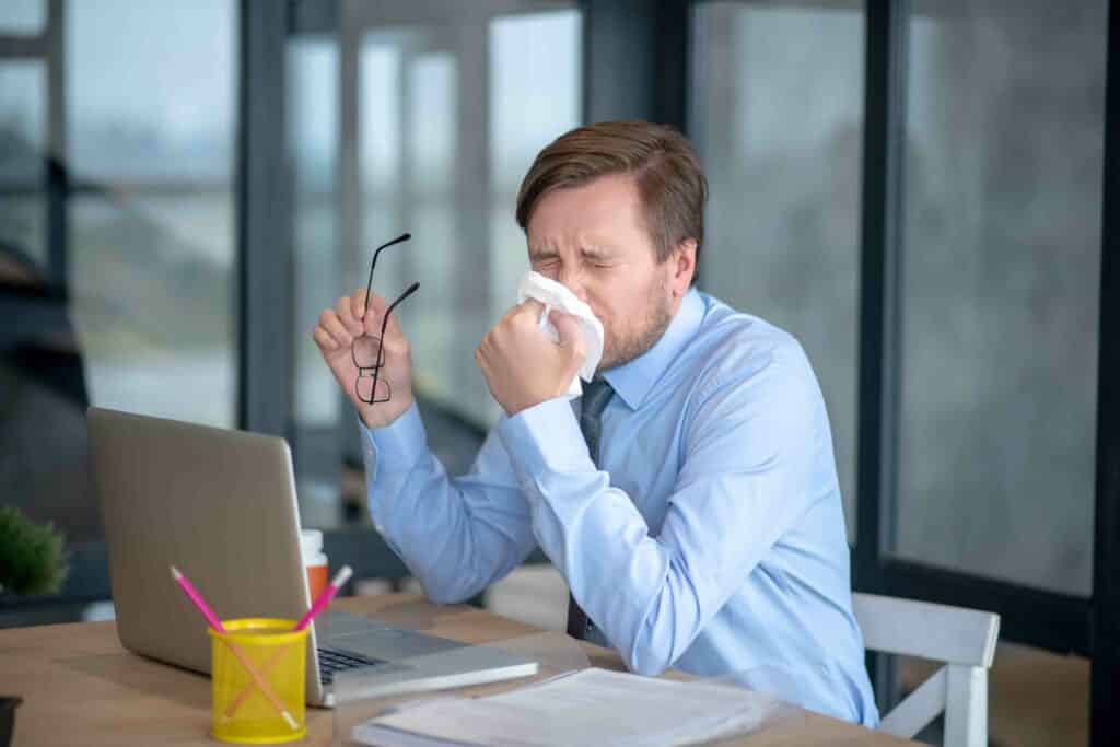 office-cleaning-disinfecting-flu-season-employee-sneezing-image